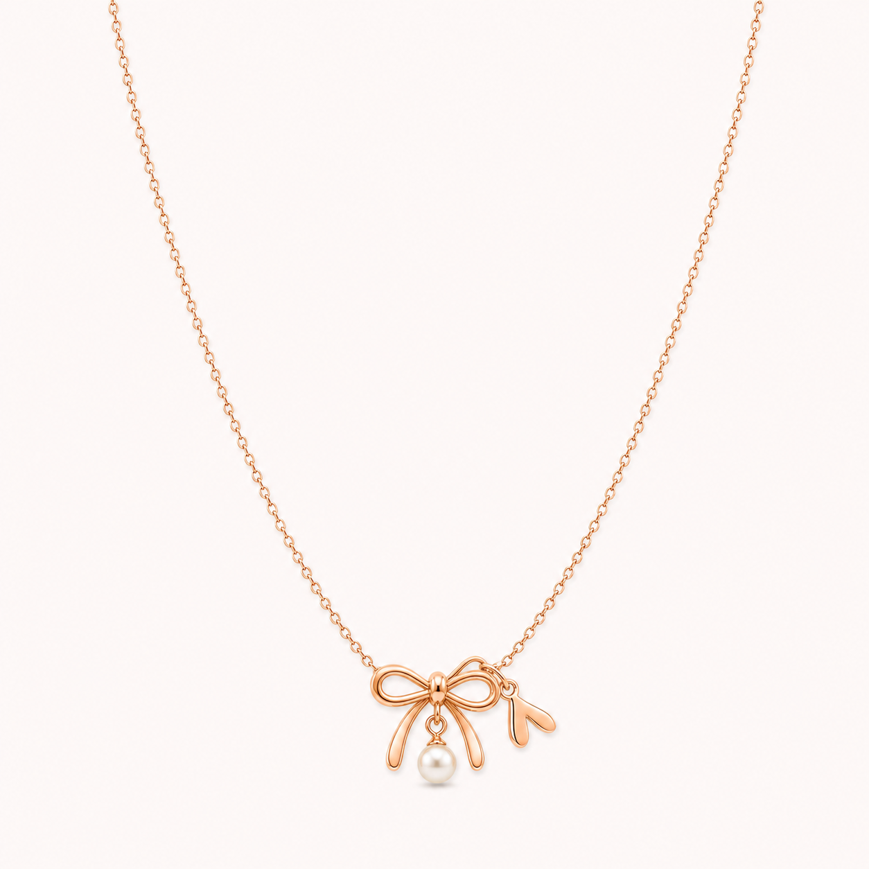 Bow Pearl Necklace clean product photo on pale blush background