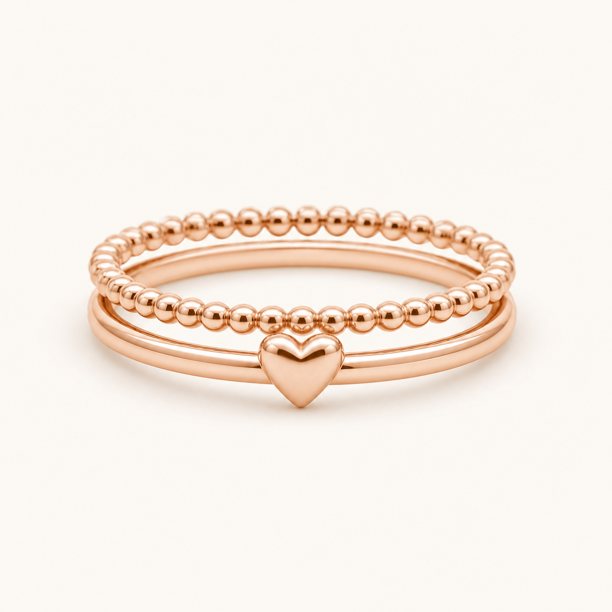 Heart Stack Rings clean product photo on creamy rose background