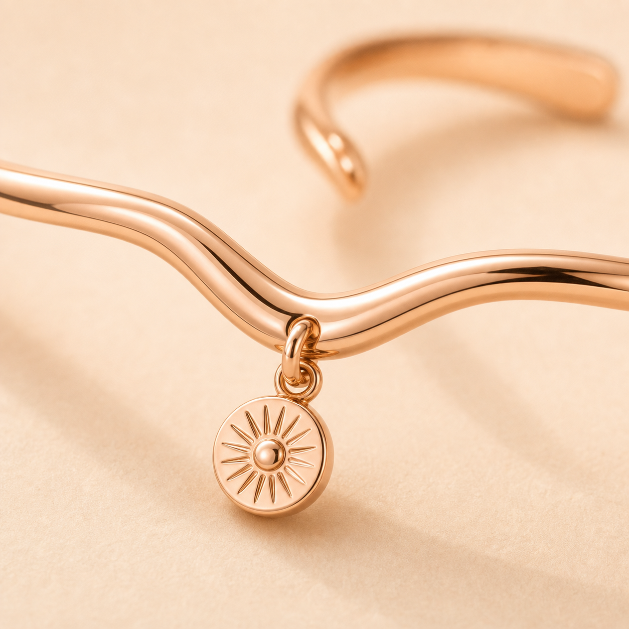 Sunshine Wave Cuff wave curve and sunburst charm detail